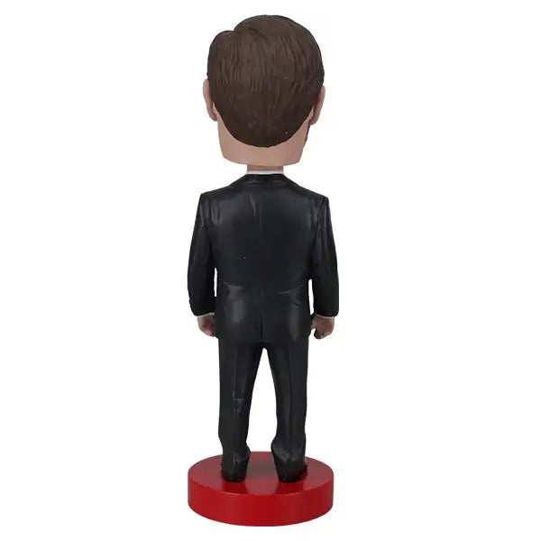 Back view of JD Vance bobblehead on a red base, showcasing the detailed craftsmanship of collectible bobbleheads.