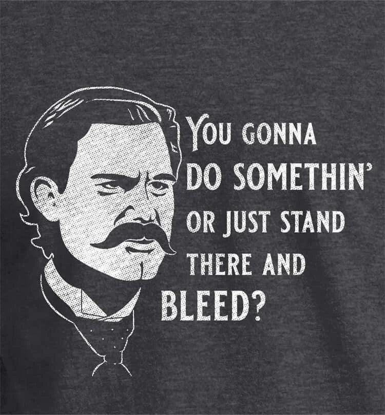 Stand There and Bleed T-Shirt featuring a character with the text "You gonna do somethin' or just stand there and bleed?"